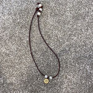 Shotgun shell and pearl necklace